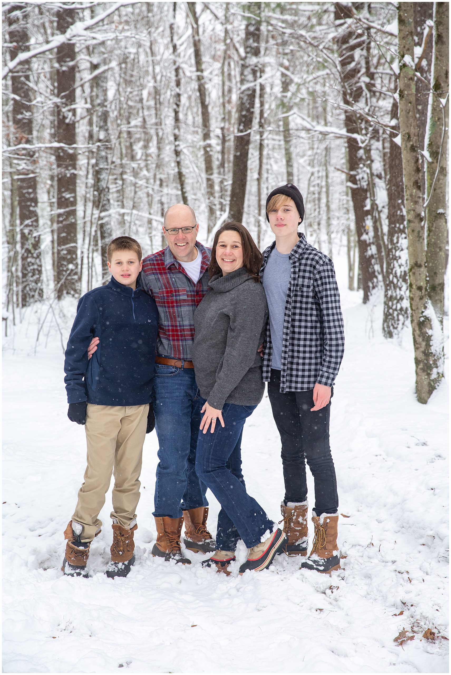 A family poses on a snowy trail