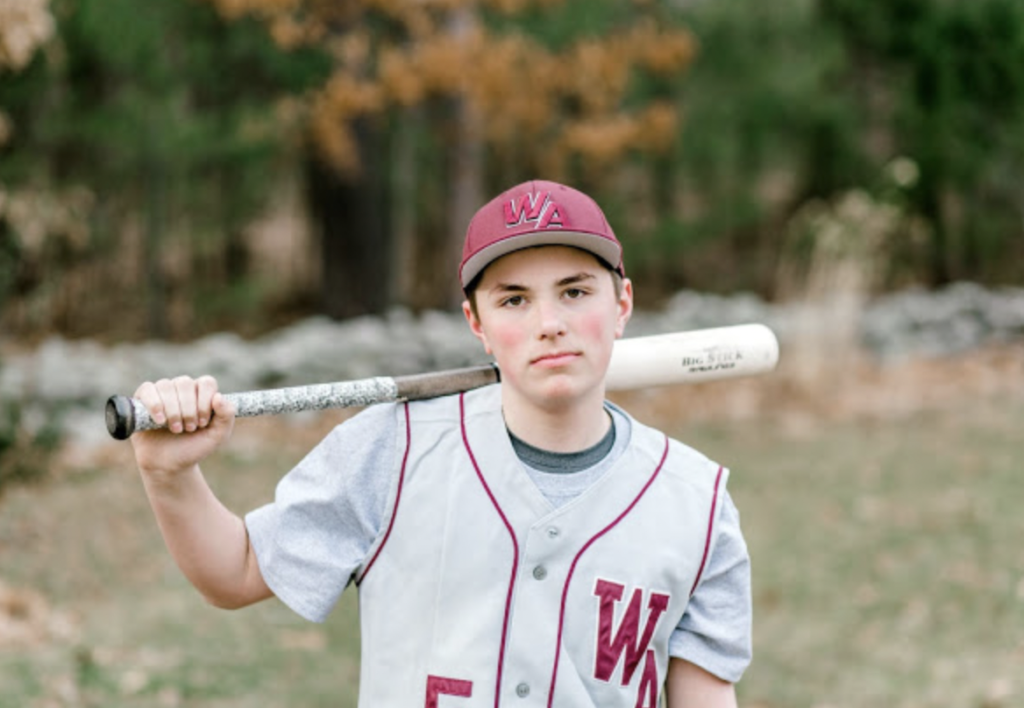 Baseball Player holds bat