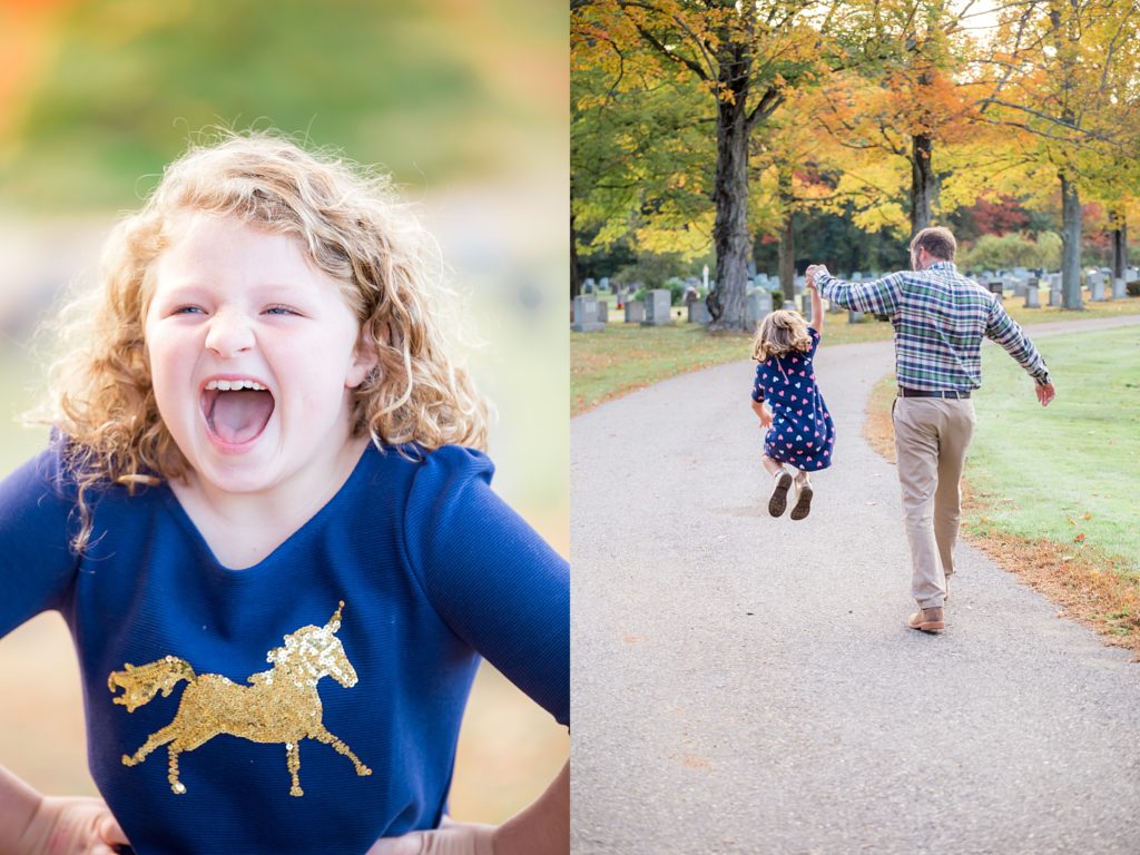 A girl wearing blue laughs. A dad holds the hand of his daughter who is jumping.